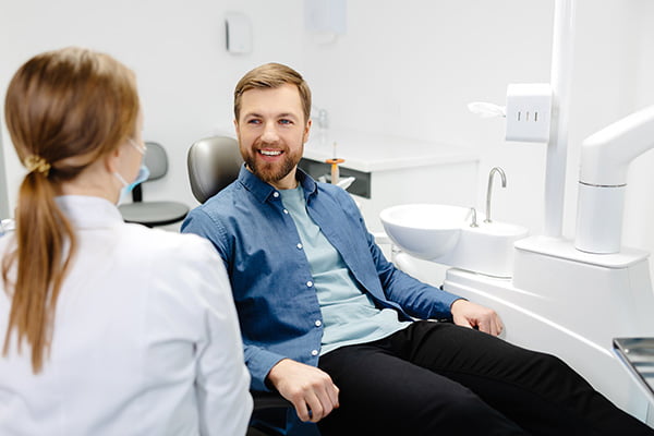Dentist discussing the Canadian Dental Care Plan (CDCP) and full-arch implant treatment options with a patient