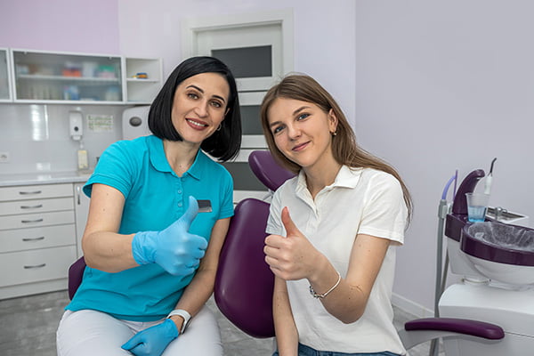 Dental team with a smiling patient at Skymark Smile Centre, highlighting patient-focused care and experienced dentists