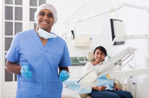 Smiling dentist at a Mississauga dental clinic providing care for patients covered by the Canadian Dental Care Plan.