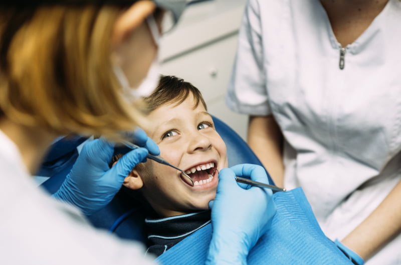 Dentist providing a dental check-up for a child in Mississauga