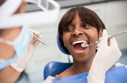 Patient receiving professional dental cleaning from a dental hygienist in a Mississauga clinic for plaque removal and preventive care.