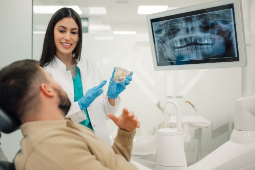 A dental professional explaining treatment options to a patient during a consultation at a Mississauga dental clinic.