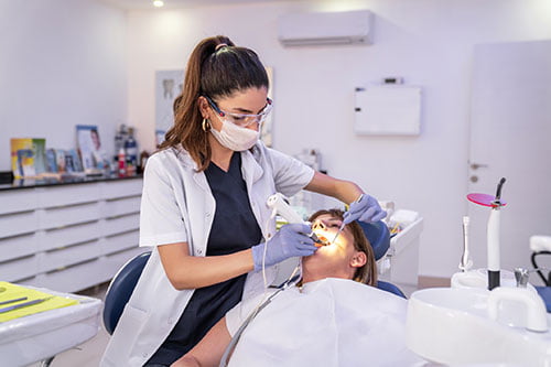 Dentist providing clear and ethical dental treatment while discussing care with a patient