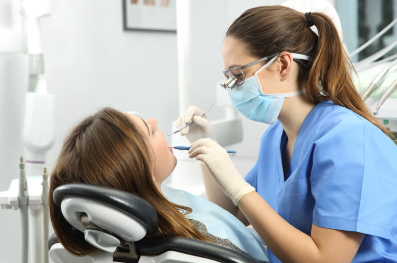 Dentist examining a patient's teeth during a dental check-up in Mississauga