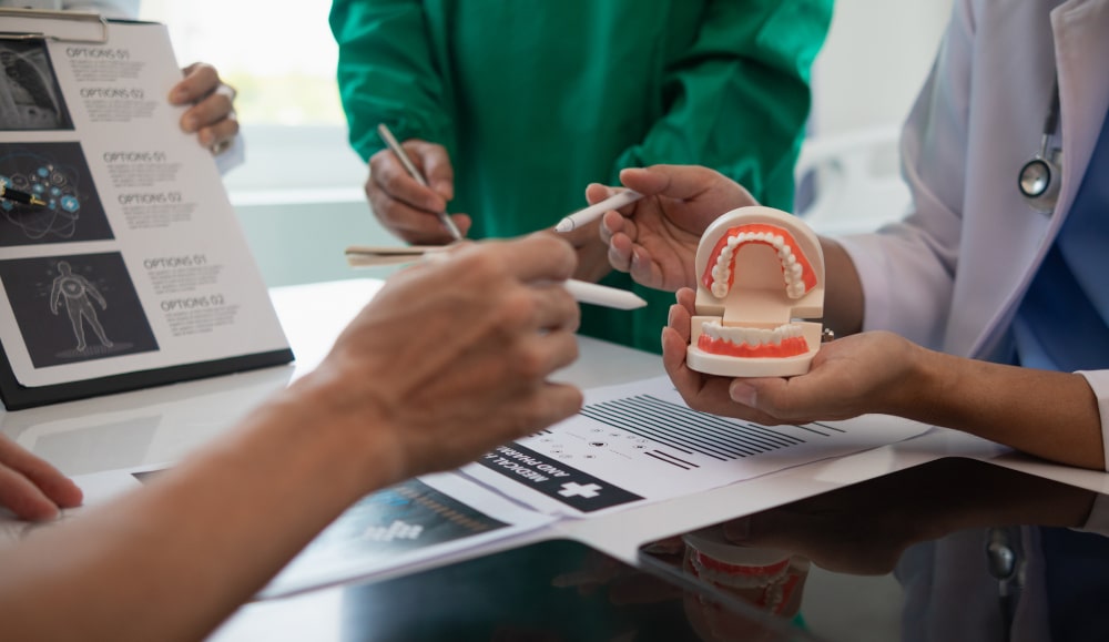 Team of Canadian dentists discussing dental treatment and insurance coverage