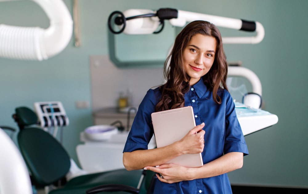 Young Canadian dentist ready for patient consultation on dental coverage options