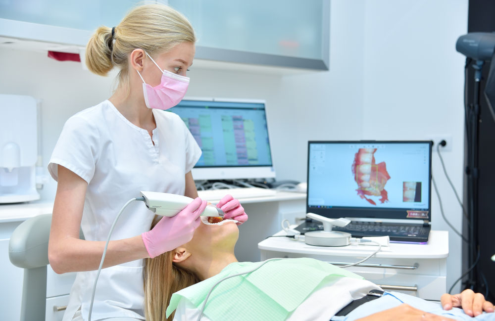 Step-by-Step Dental Bonding Process in Cosmetic Dentistry Dentist using an intraoral scanner on a patient, representing preparation and precision involved in modern aesthetic dental bonding.