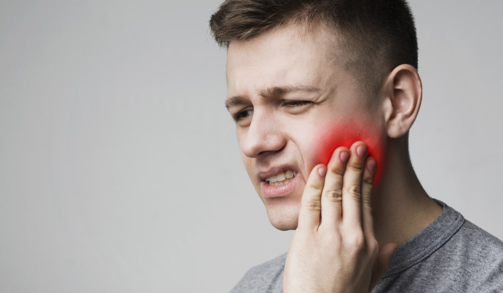 Symptoms of sensitive teeth, like sharp pain, and discomfort