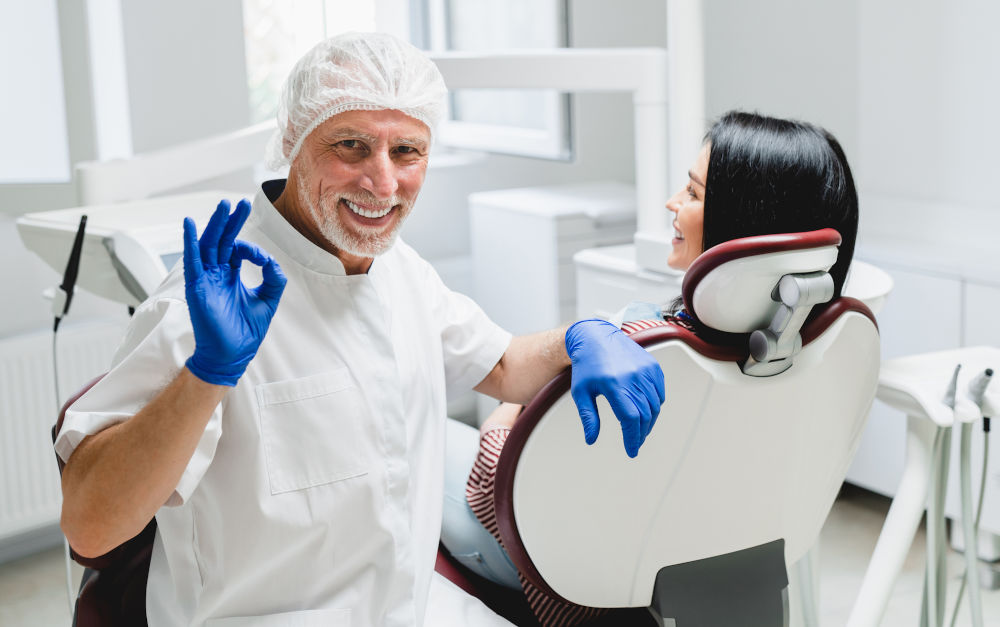 Dentist performing a cosmetic dental procedure, illustrating careful clinical assessment and precision required when planning porcelain veneers.