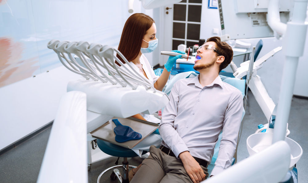 Patient seated in a dental chair during treatment, representing the step-by-step porcelain veneer placement process and patient experience.